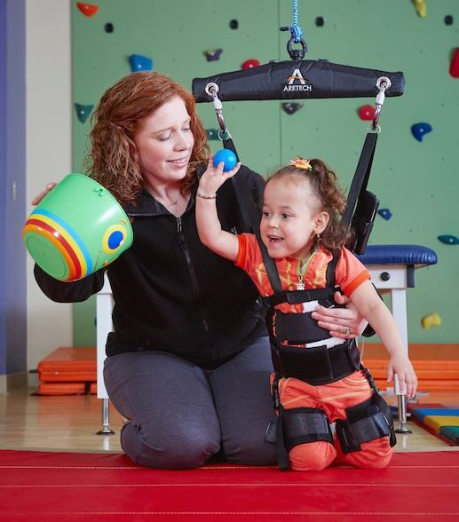 A nurse helping our Toddler patient practice gait balance during Physiotherapy