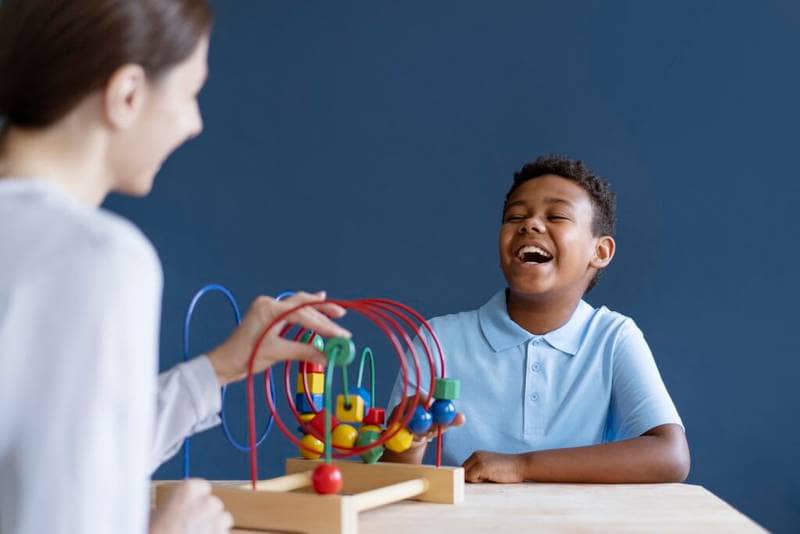 a patient laughing during a behavioral modification therapy session